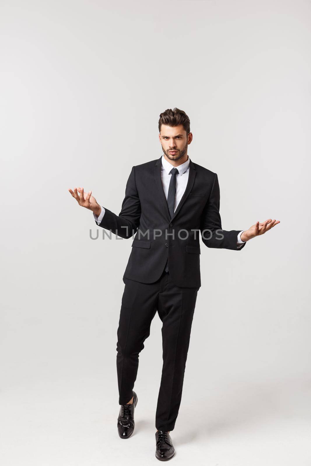 Portrait onfident young handsome businessman or model looking at camera isolated on white background.