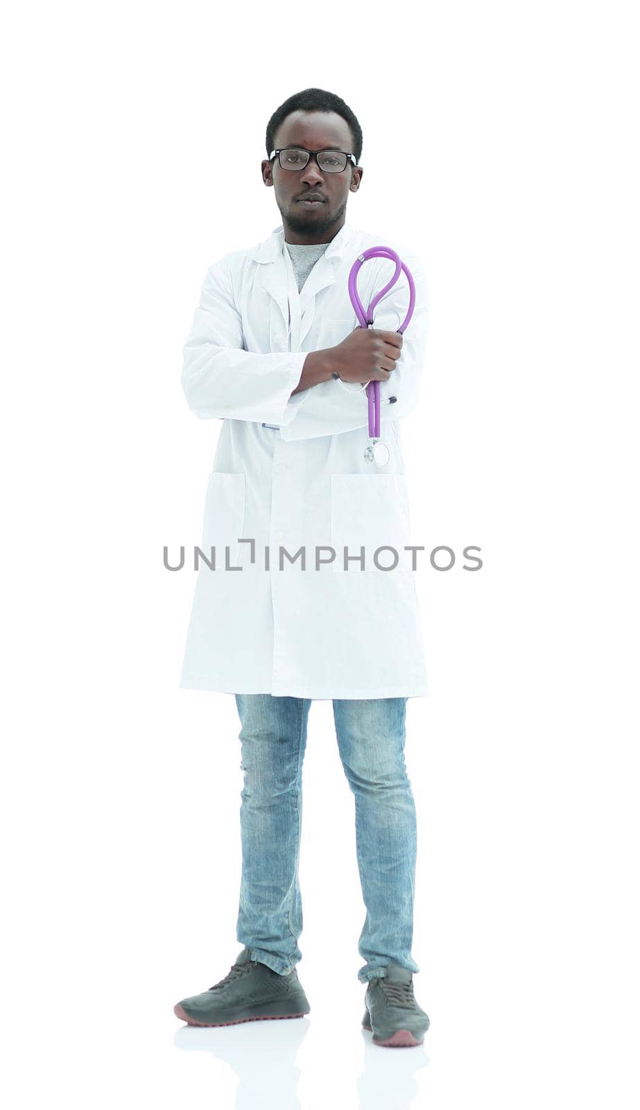 in full growth. smiling doctor looking at the camera. isolated on white