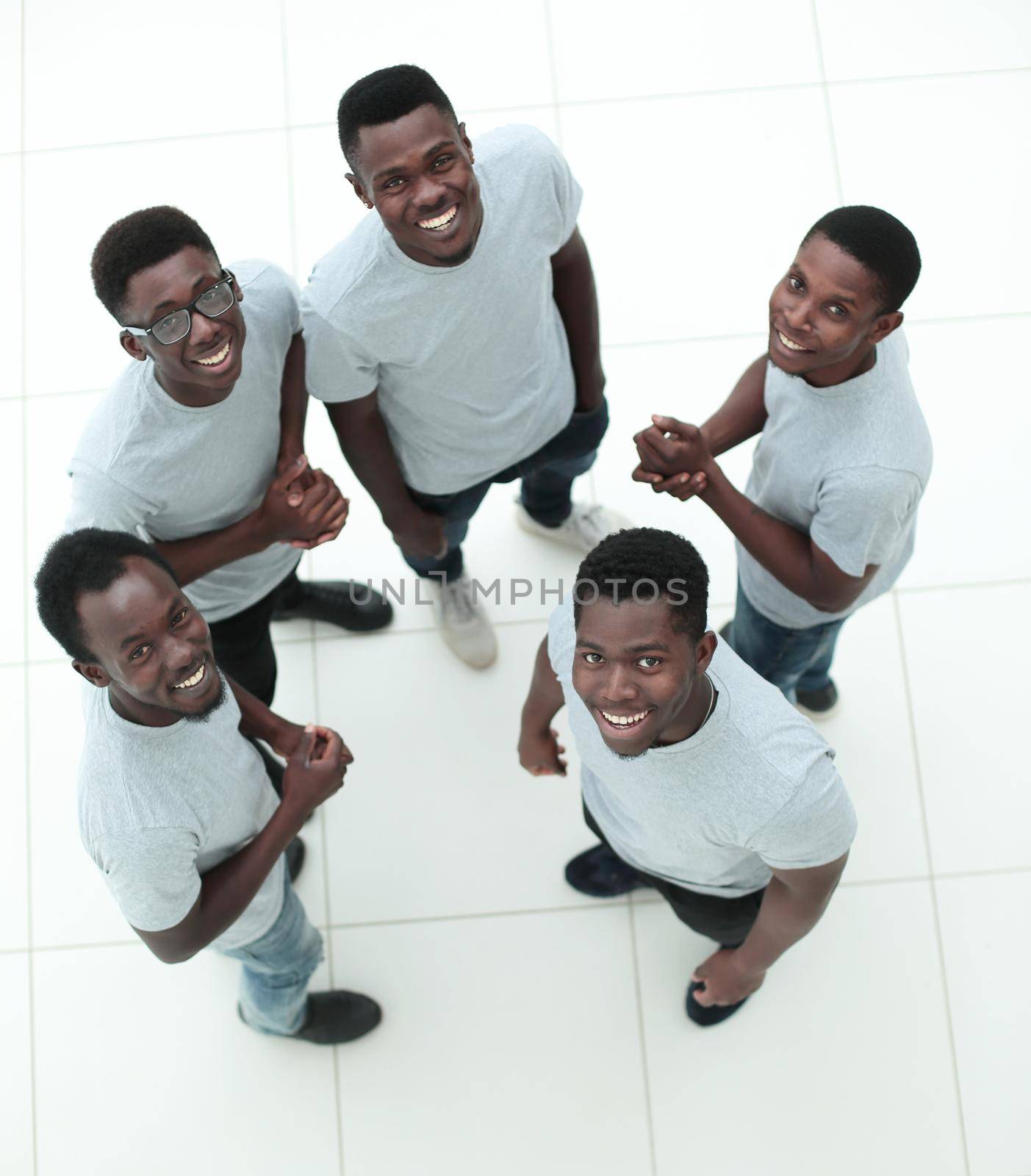 top view. group of guys standing in a circle and looking at the camera . isolated on white