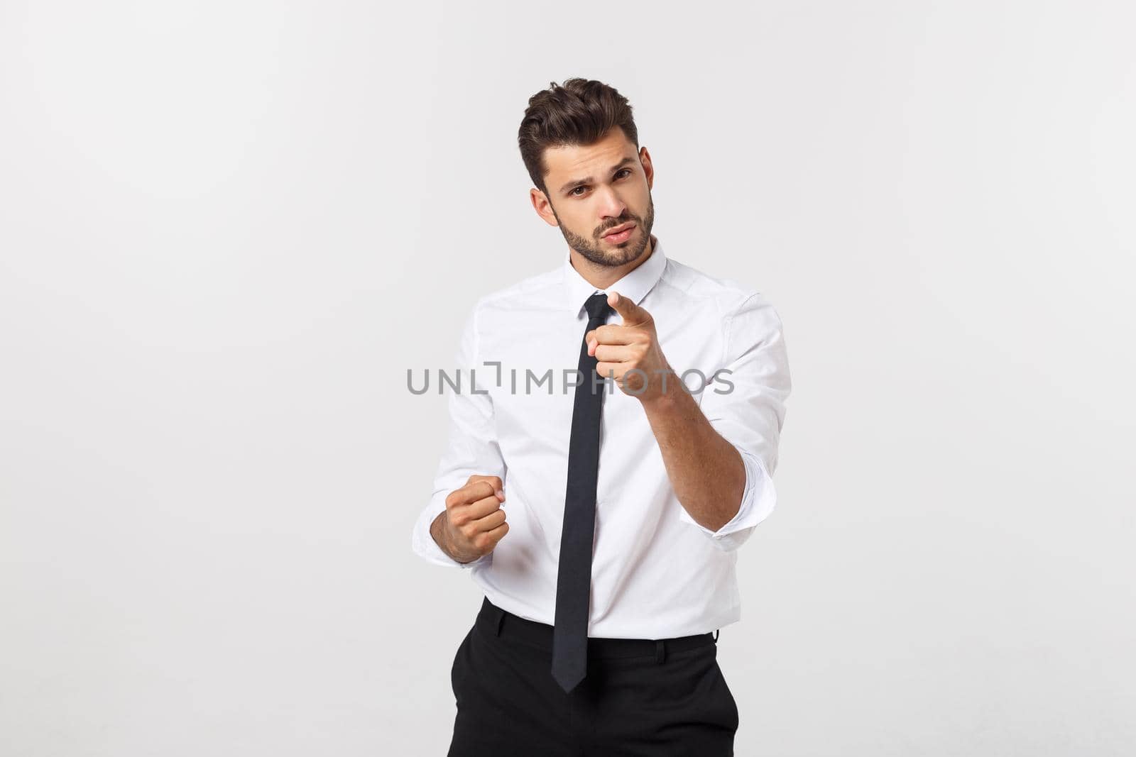 Portrait businessman angry and pointing finger at you over isolated white background.