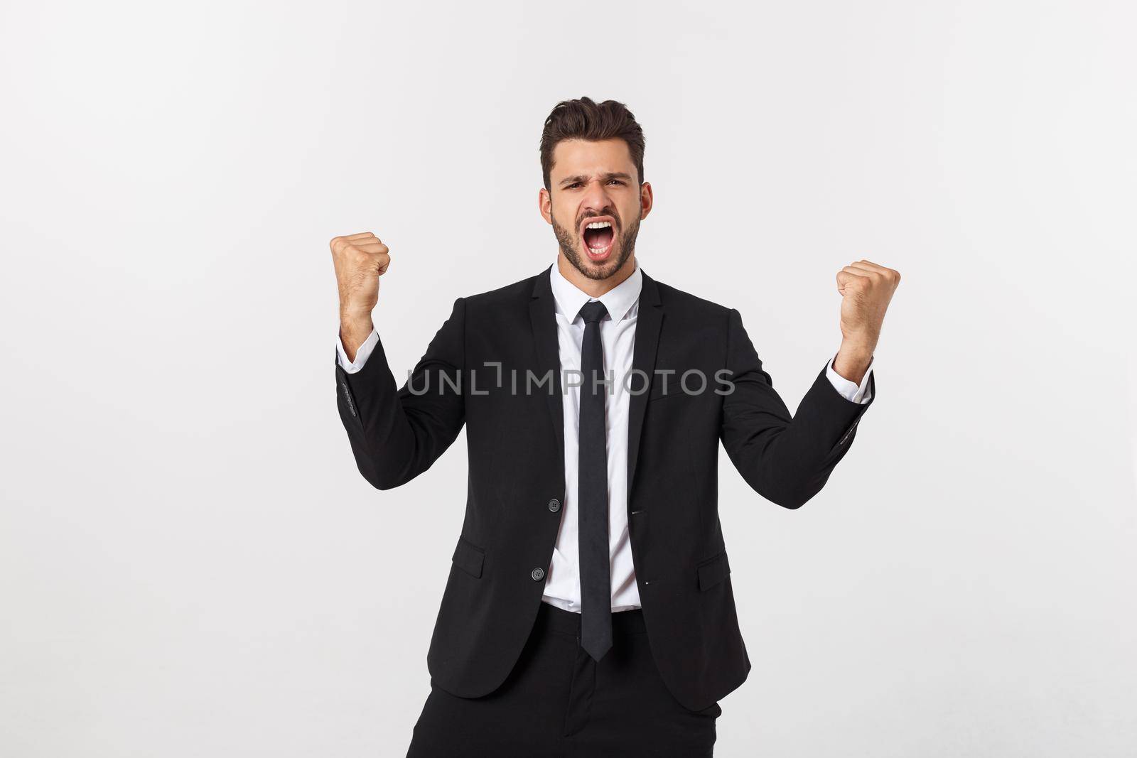 Portrait of a energetic young business man enjoying success, screaming against white - Isolated. by Benzoix