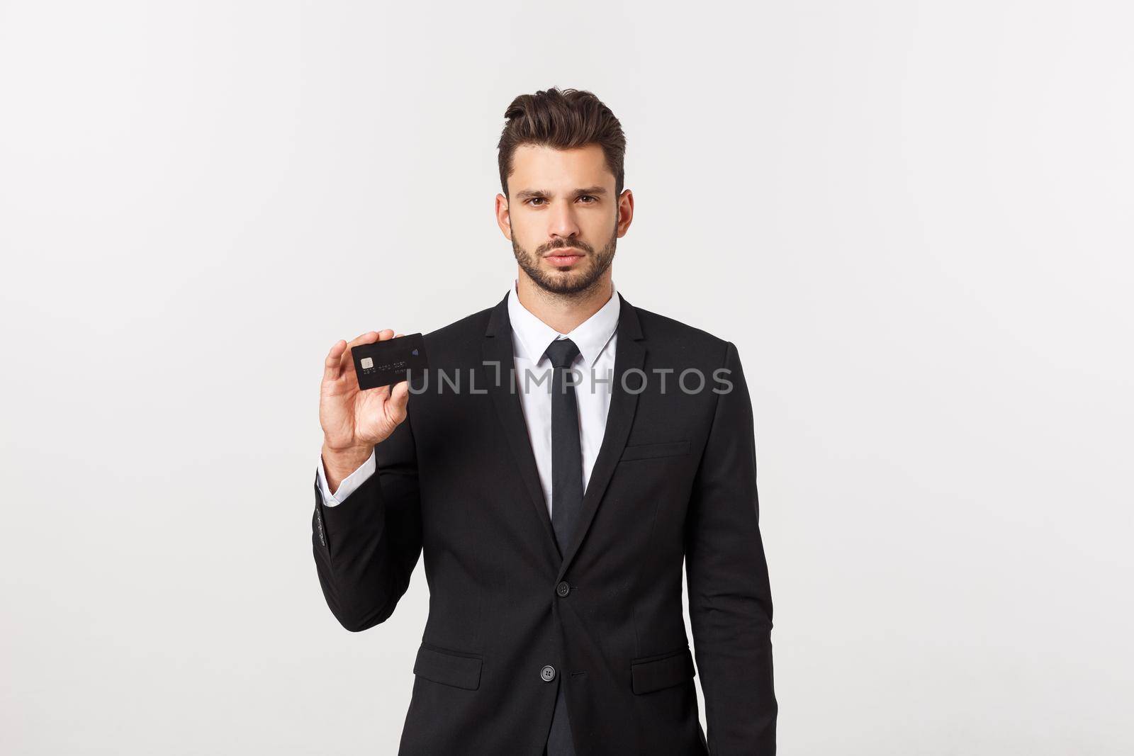 Surprised, speechless and impressed handsome caucasian businessman in classic suit showing credit card, say wow, standing white background astonished by Benzoix