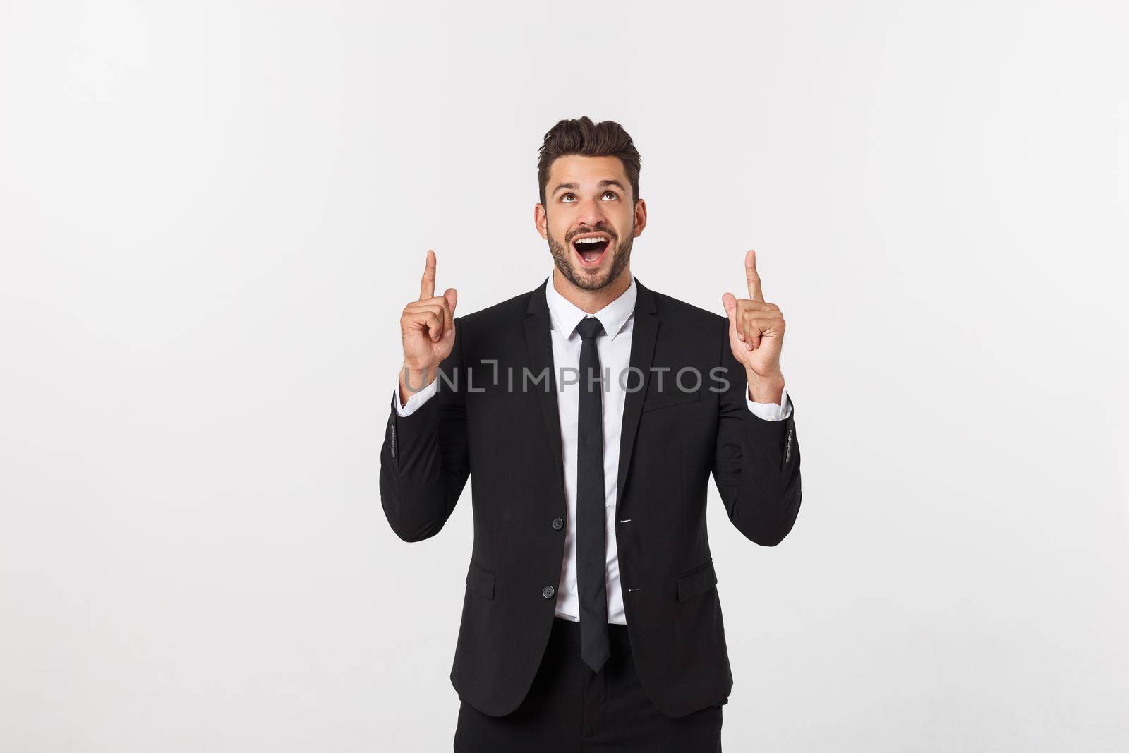 Business Concept: Portrait handsome young businessman point finger on side to empty copy space. Isolated over white background by Benzoix