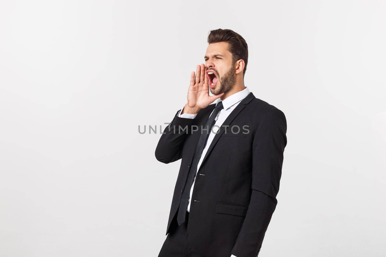 Businessman with long beard over isolated background shouting with mouth wide open.