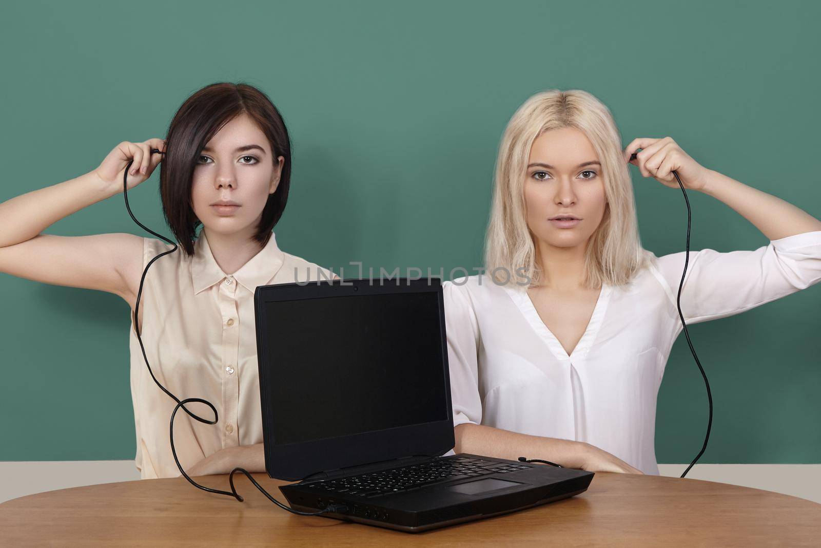 Girls connecting black laptop. Distance Learning, home schooling. Cybernetic age in Internet. Opportunity for work and education.