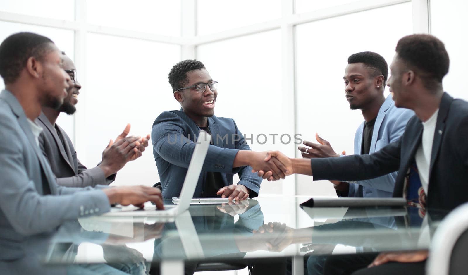 happy business partners shaking hands at meeting in the office. concept of cooperation
