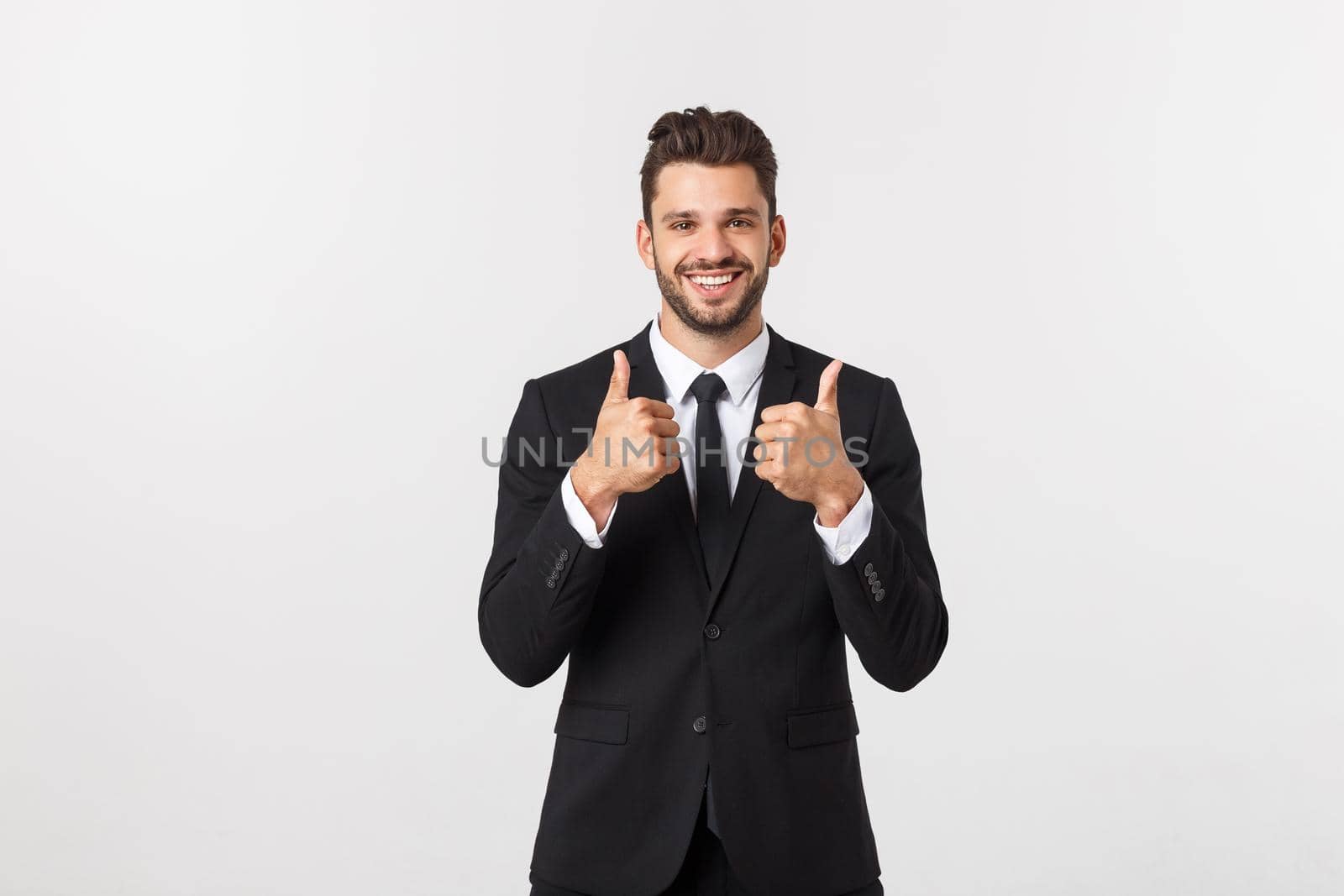 Portrait businessman showing thumbs-up sign on white background.