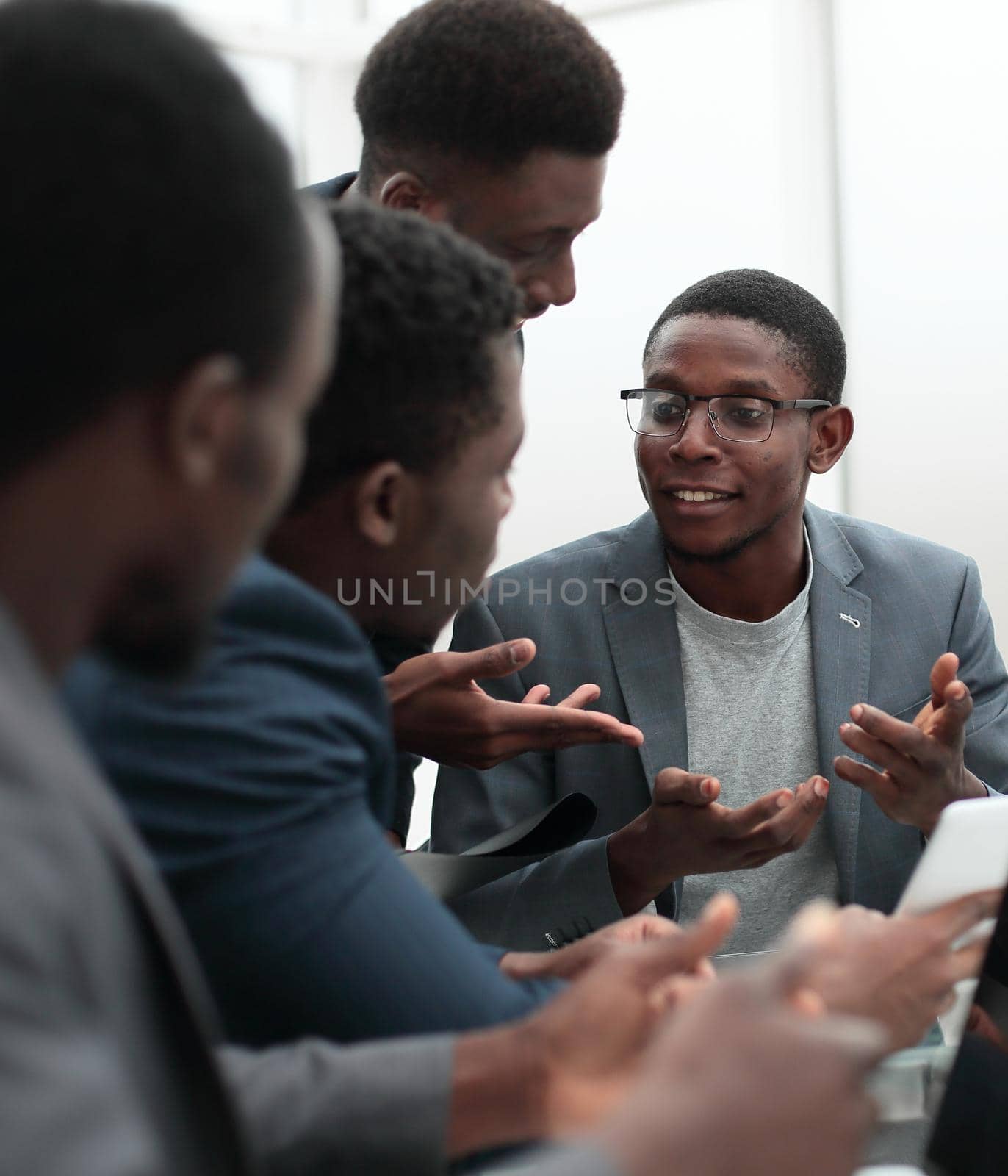 group of employees looking at the screen of a digital tablet. the concept of a startu