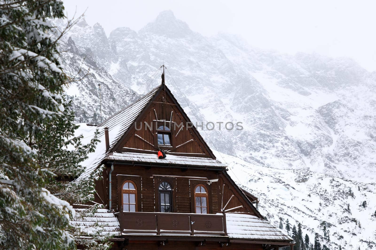The old wooden house on the background of the winter mountains by castenoid