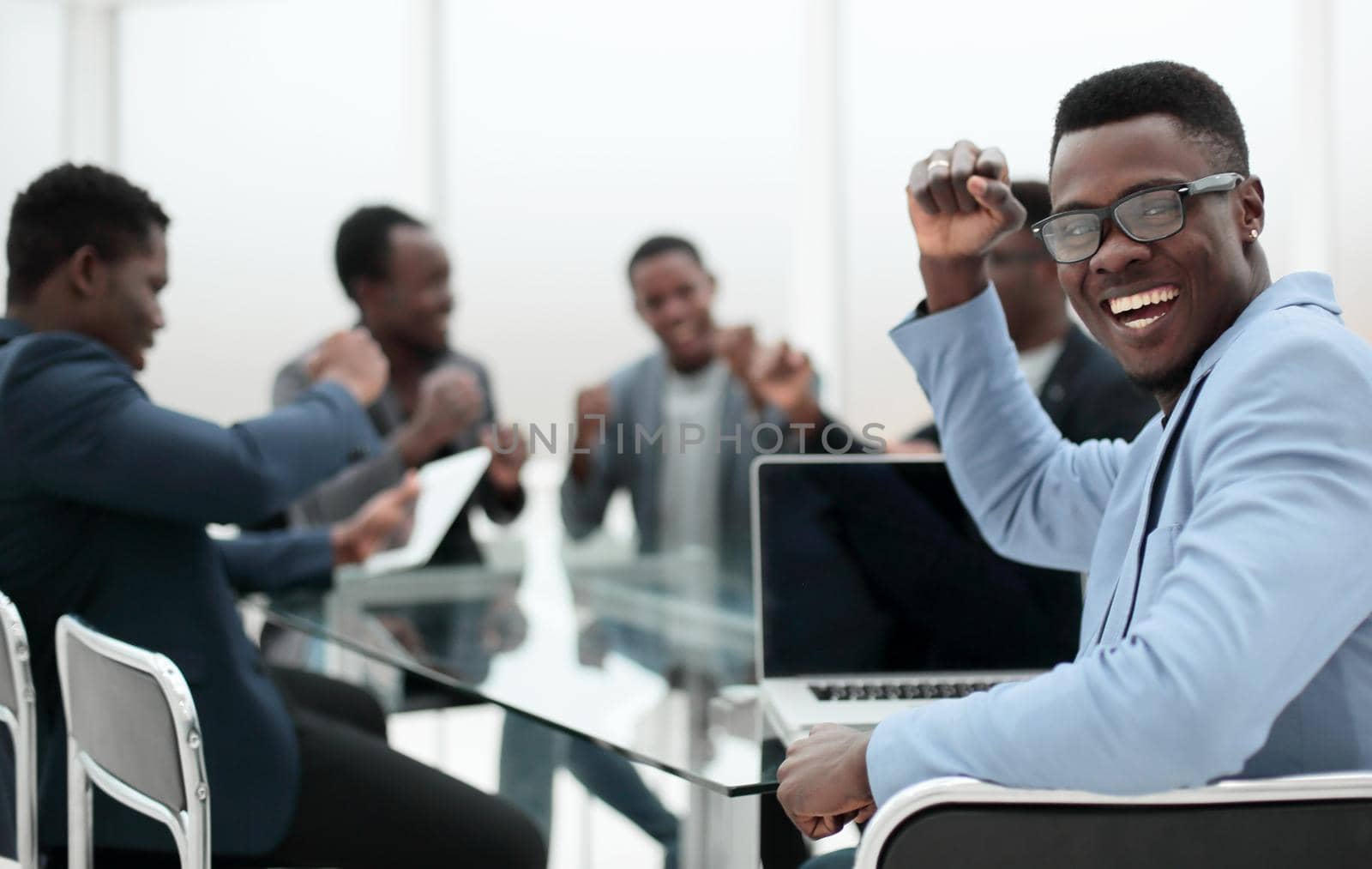 rear view . happy young businessman sitting at office Desk . photo with copy space