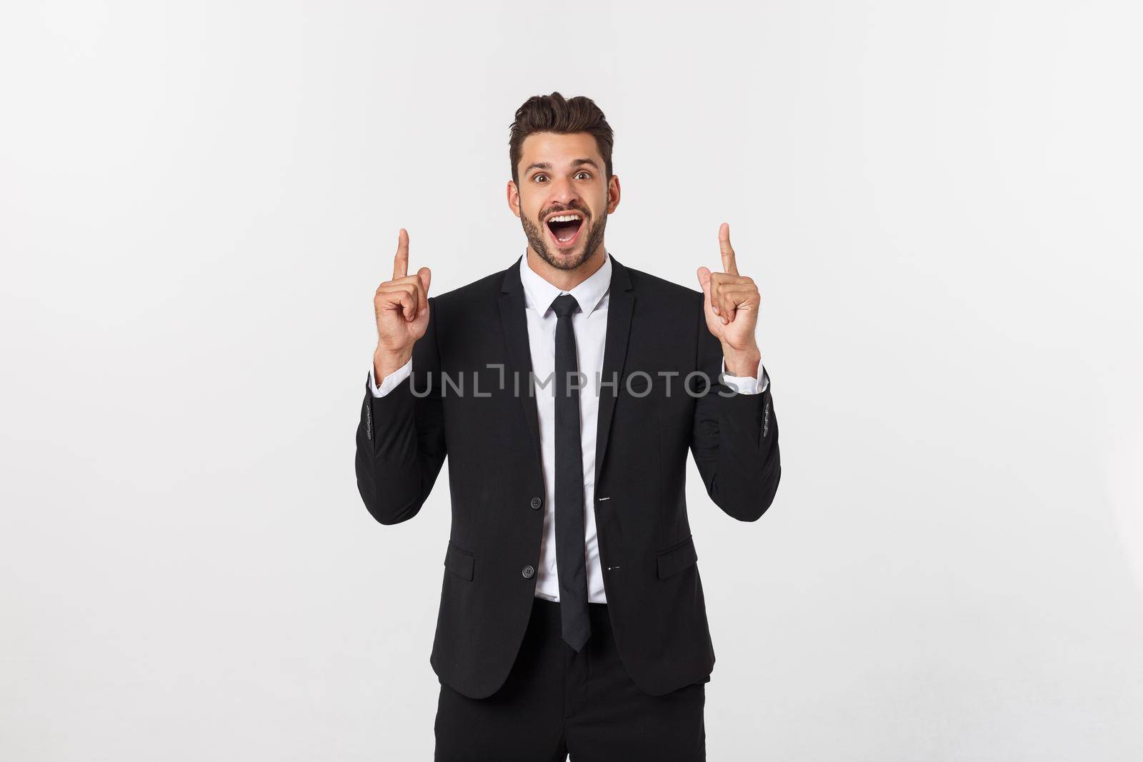 Business Concept: Portrait handsome young businessman point finger on side to empty copy space. Isolated over white background.