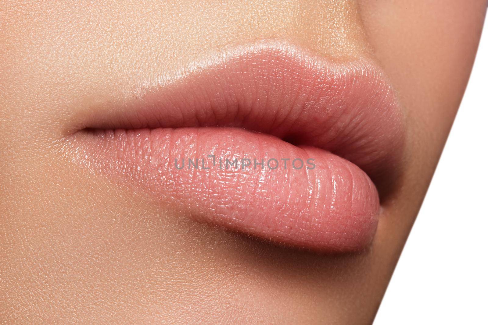 Close-up perfect natural lip makeup beautiful female mouth. Plump sexy full lips. Macro photo face detail. Perfect clean skin, fresh lip make-up. Beautiful spa tender lips