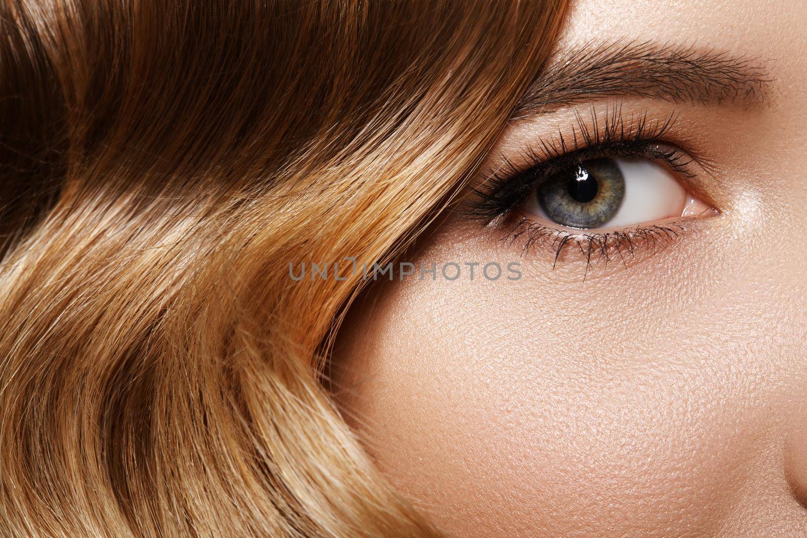 Beautiful Macro Shot of Female Eye with Classic Makeup. Good Vision. Perfect Curly Long Lashes, Wavy Shiny Hair. Retro Beauty Concept