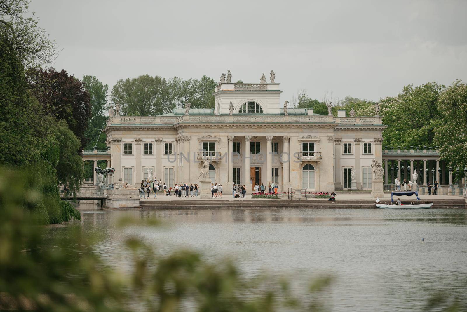 Warsaw, Poland - MAY 12, 2022: The view from the water of Palace on the Isle at noon
