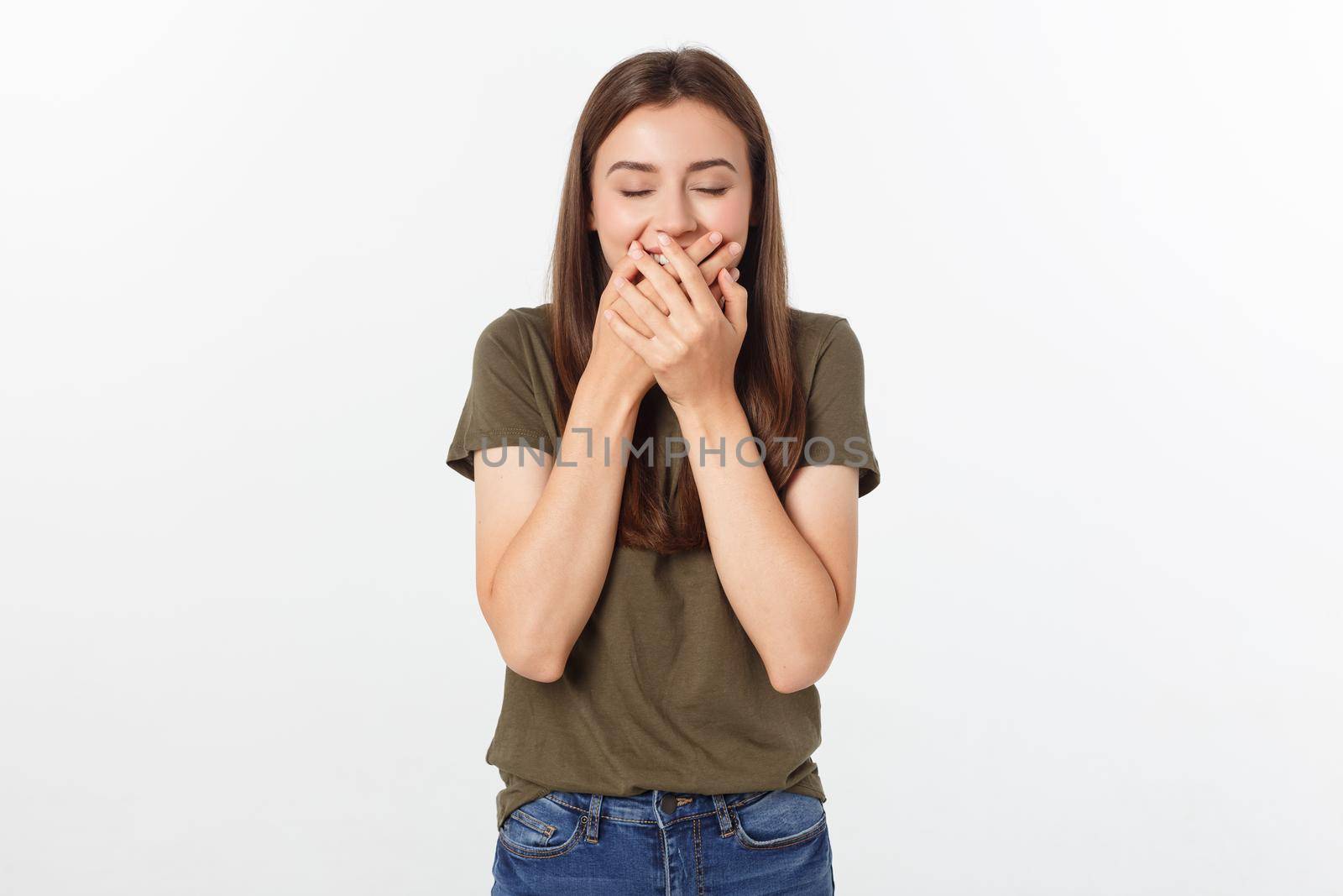 Happy woman laughing covering her mouth with a hands isolate over grey background