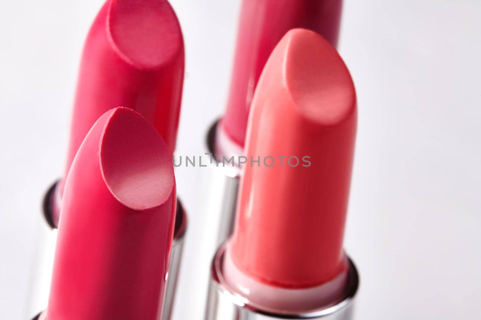 Beautiful set of lipsticks in red colors. Beauty cosmetic collection. Macro close up shot. Fashion trends in cosmetics with bright lips, delisious textures