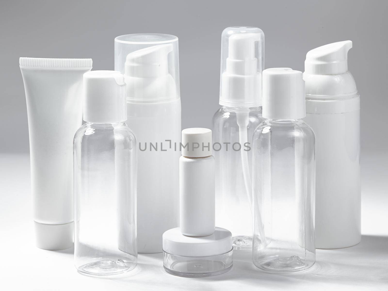 White cosmetic bottles on white background. Wellness, spa and body care bottles collection. Beauty treatment, bathroom set