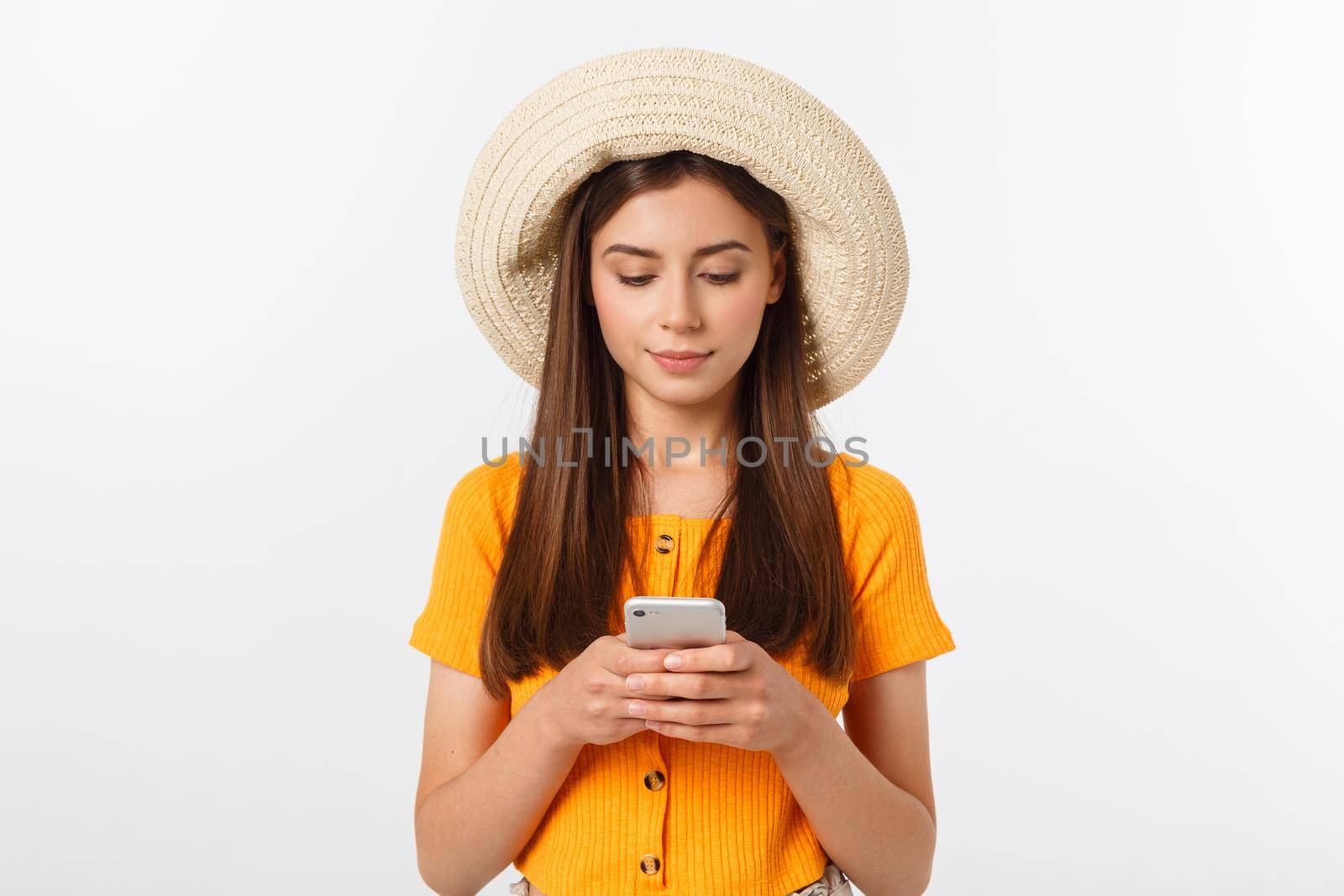 Woman sending a sms on cell phone, isolated on white background.