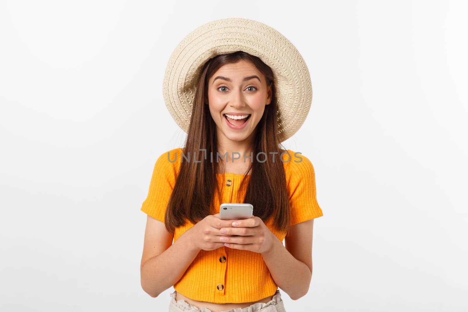 Happy young caucasian woman using smartphone standing isolated on white