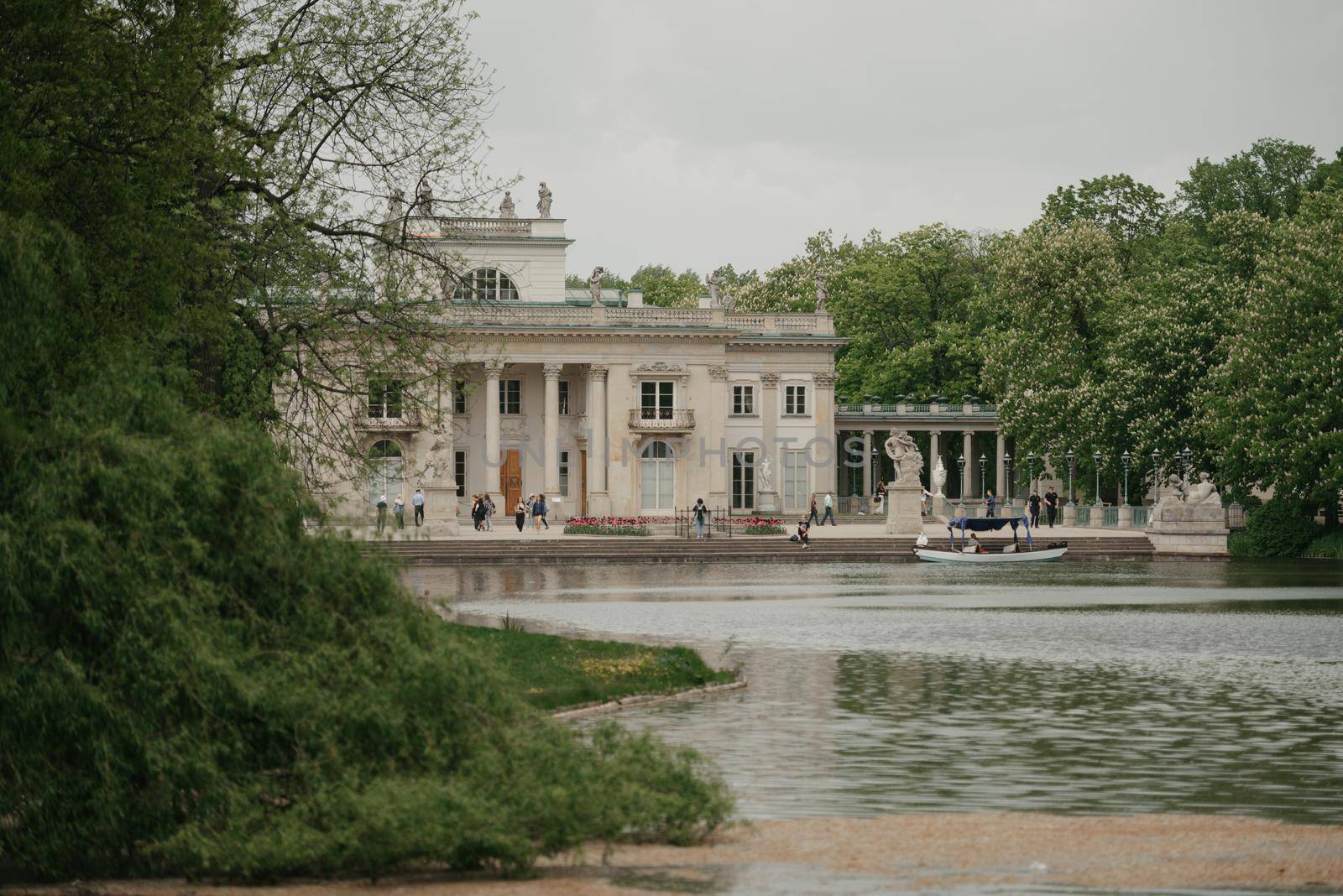 Warsaw, Poland - MAY 12, 2022: The view from the water of the Palace on the Isle at noon