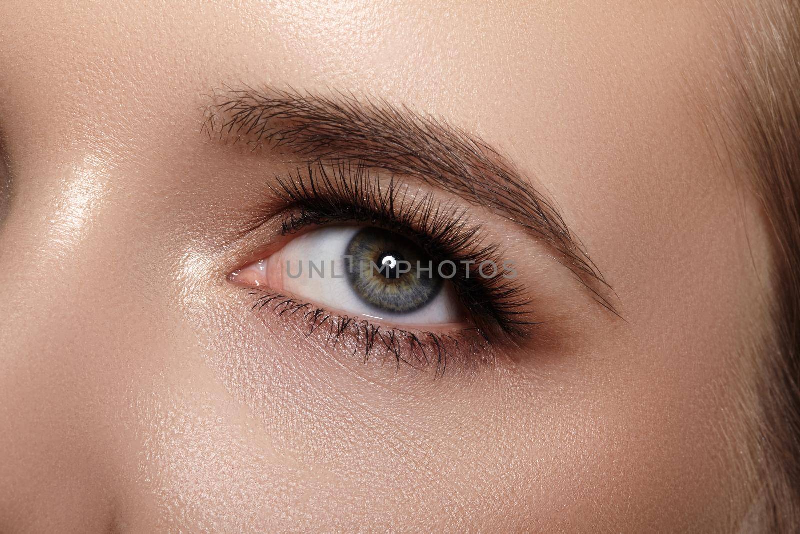 Beautiful Macro Female Eye with Extreme Long Eyelashes and Celebrate Makeup. Perfect Shape Make-up, Fashion Long Lashes. Cosmetics and make-up. Closeup macro shot of fashion eyes visage