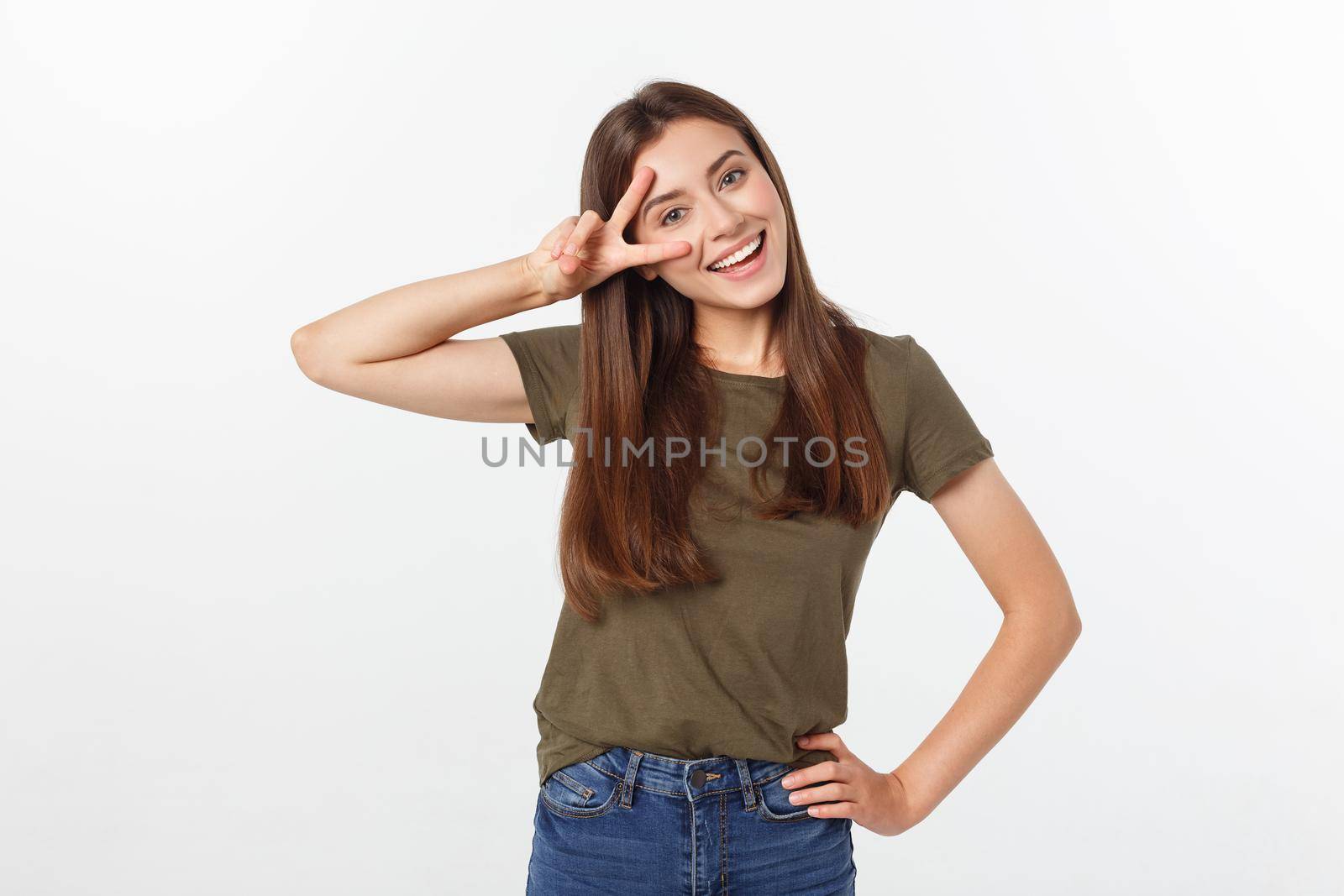 Young woman showing two fingers, positive or peace gesture, on white. by Benzoix