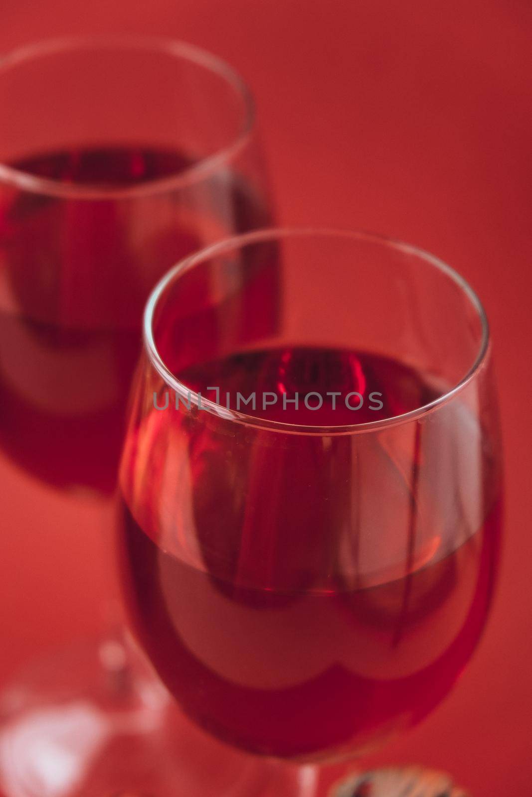 Two wine glasses with red wine on the red background. valentines day by anna_stasiia