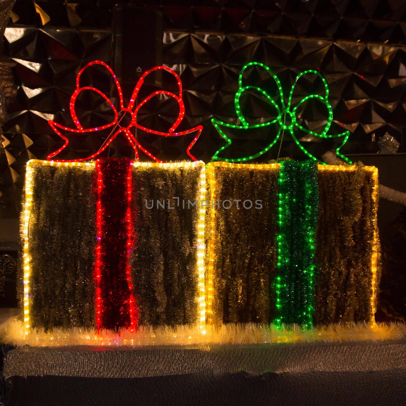 Christmas decorations in the form of boxes with gifts on a city street by SmartPhotoLab