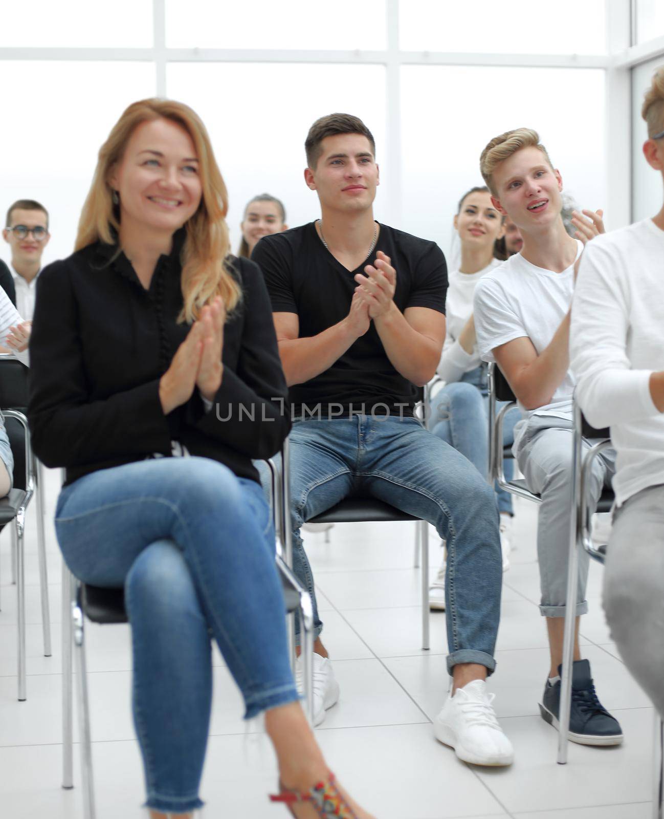 group of young people applaud at a group meeting. business and education