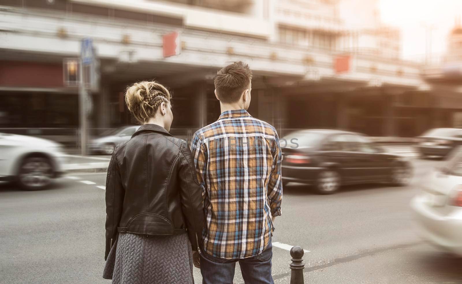 rear view: a couple in love on the streets of the big city