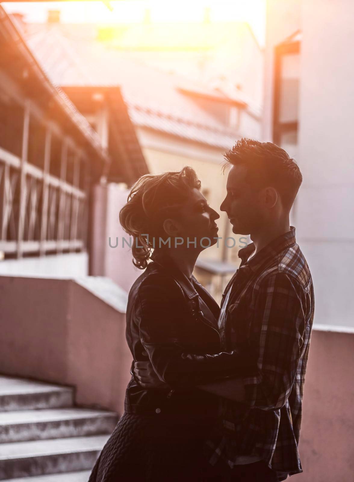 lovers hug each other on the streets of a big city by SmartPhotoLab