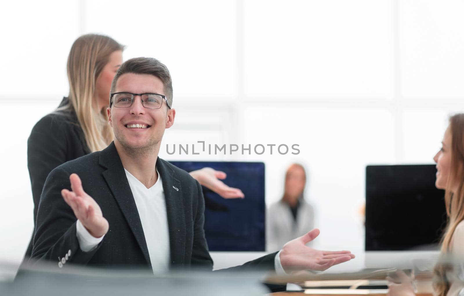 close up. smiling business man sitting at an office Desk.