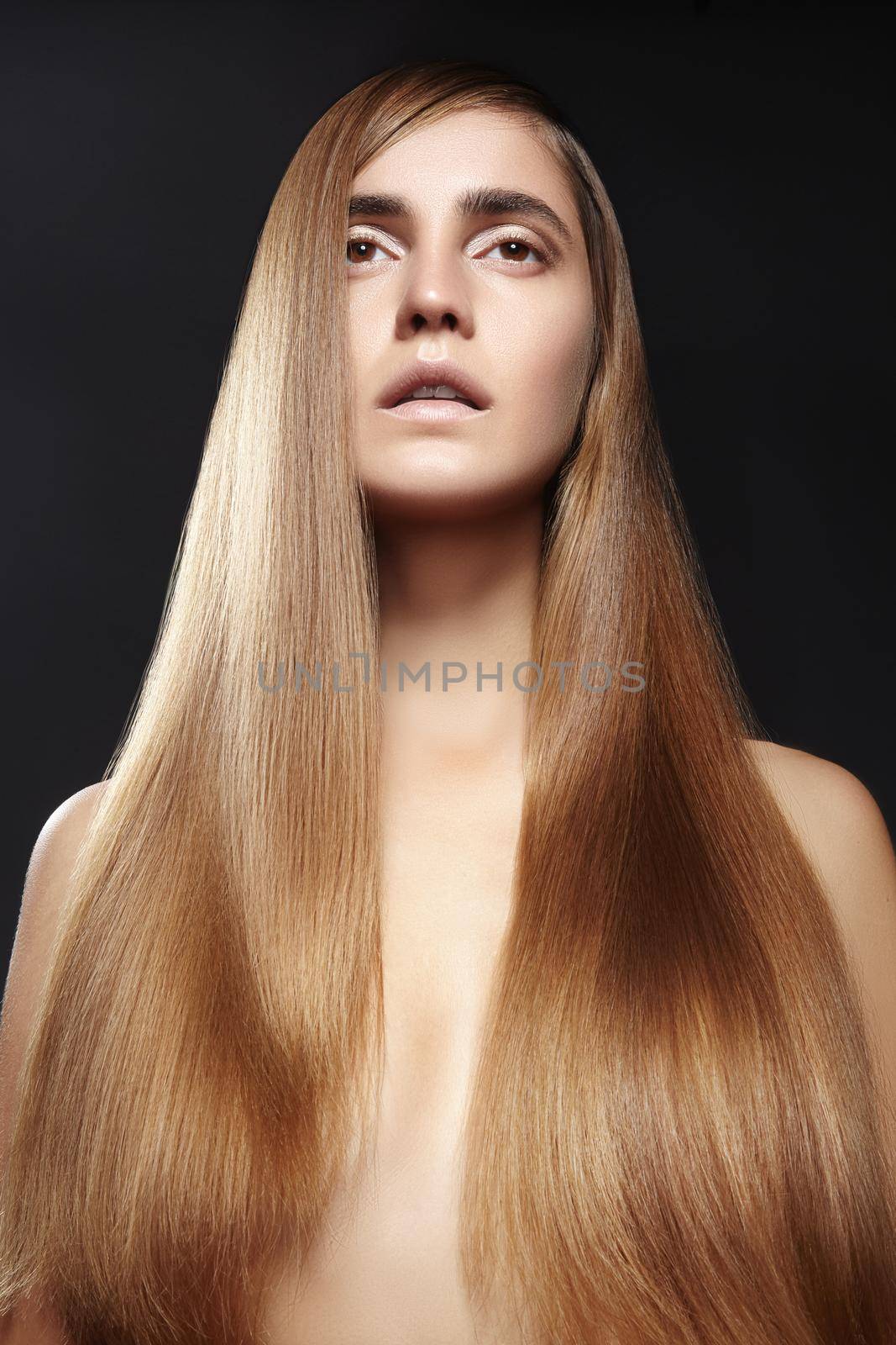 Beautiful yong woman with long straight brown hair. Sexy fashion model with smooth gloss hairstyle, keratin treatment