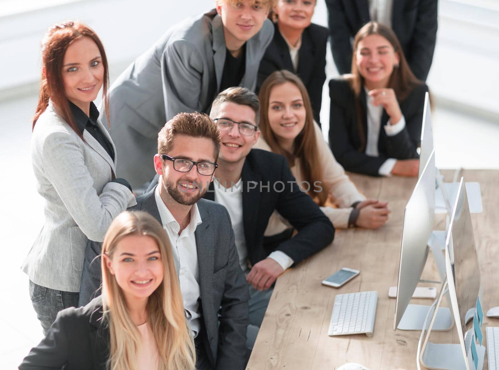 group of young professionals sitting at an office Desk. the concept of teamwork
