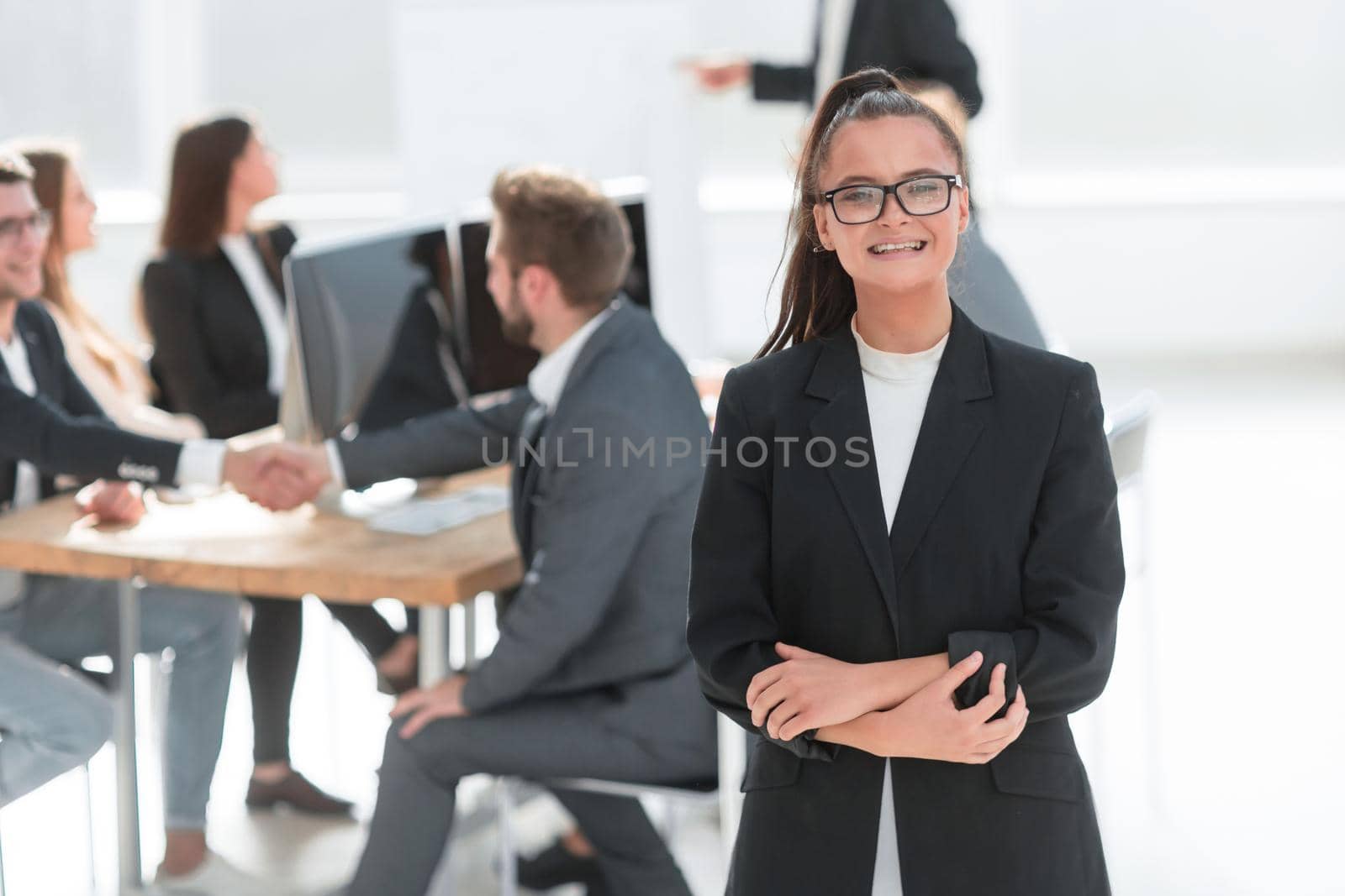 young corporate employee standing in a modern office . photo with a copy of the space