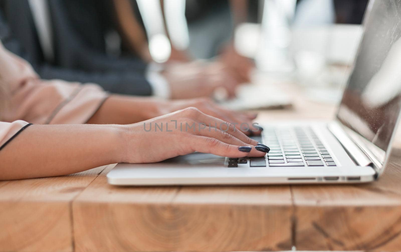 close up. a business woman uses a laptop in the workplace by asdf
