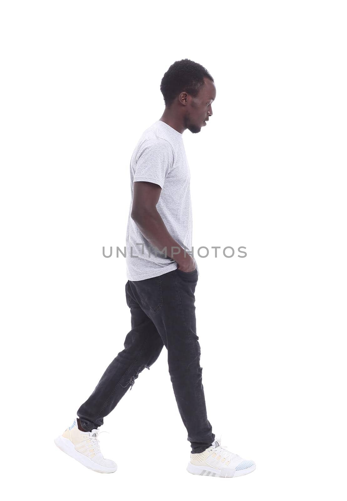 in full growth. handsome guy in jeans and a t-shirt . isolated on white