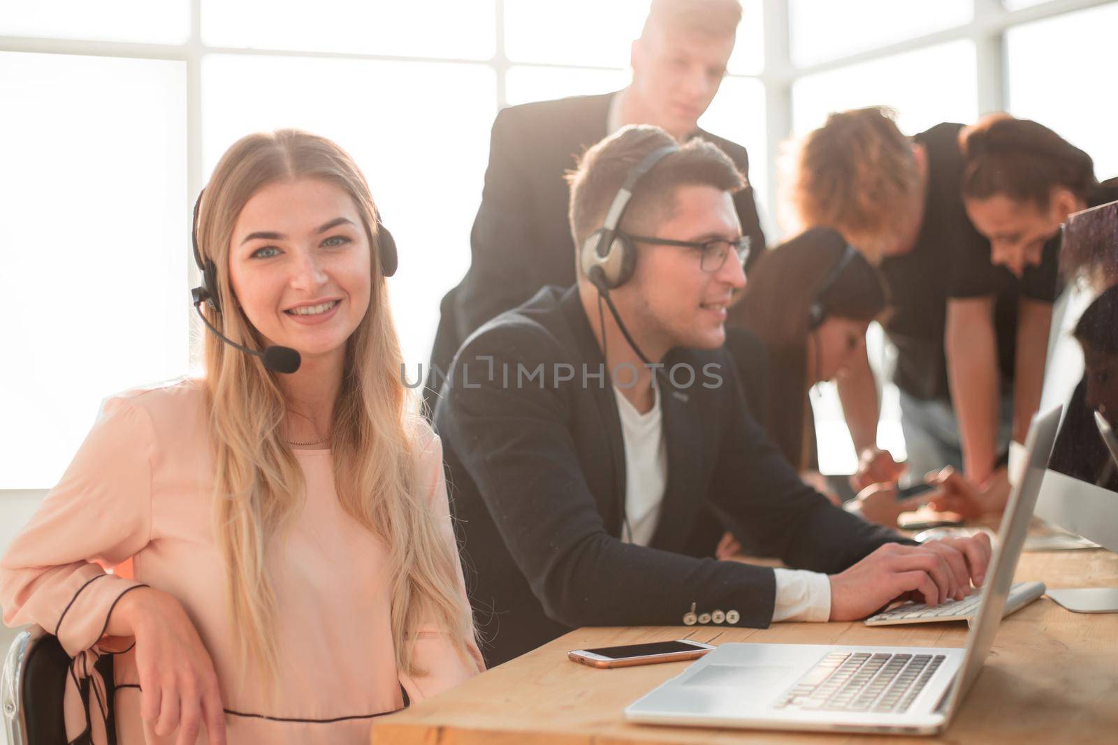 group of young employees in the workplace. by asdf