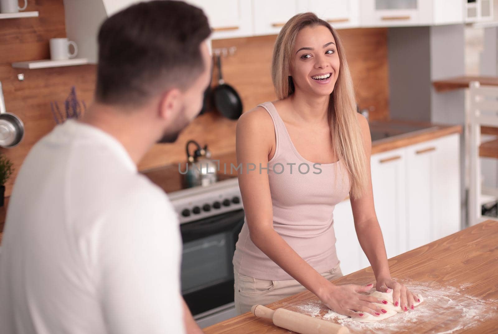 close up. young couple preparing homemade cakes in their kitchen