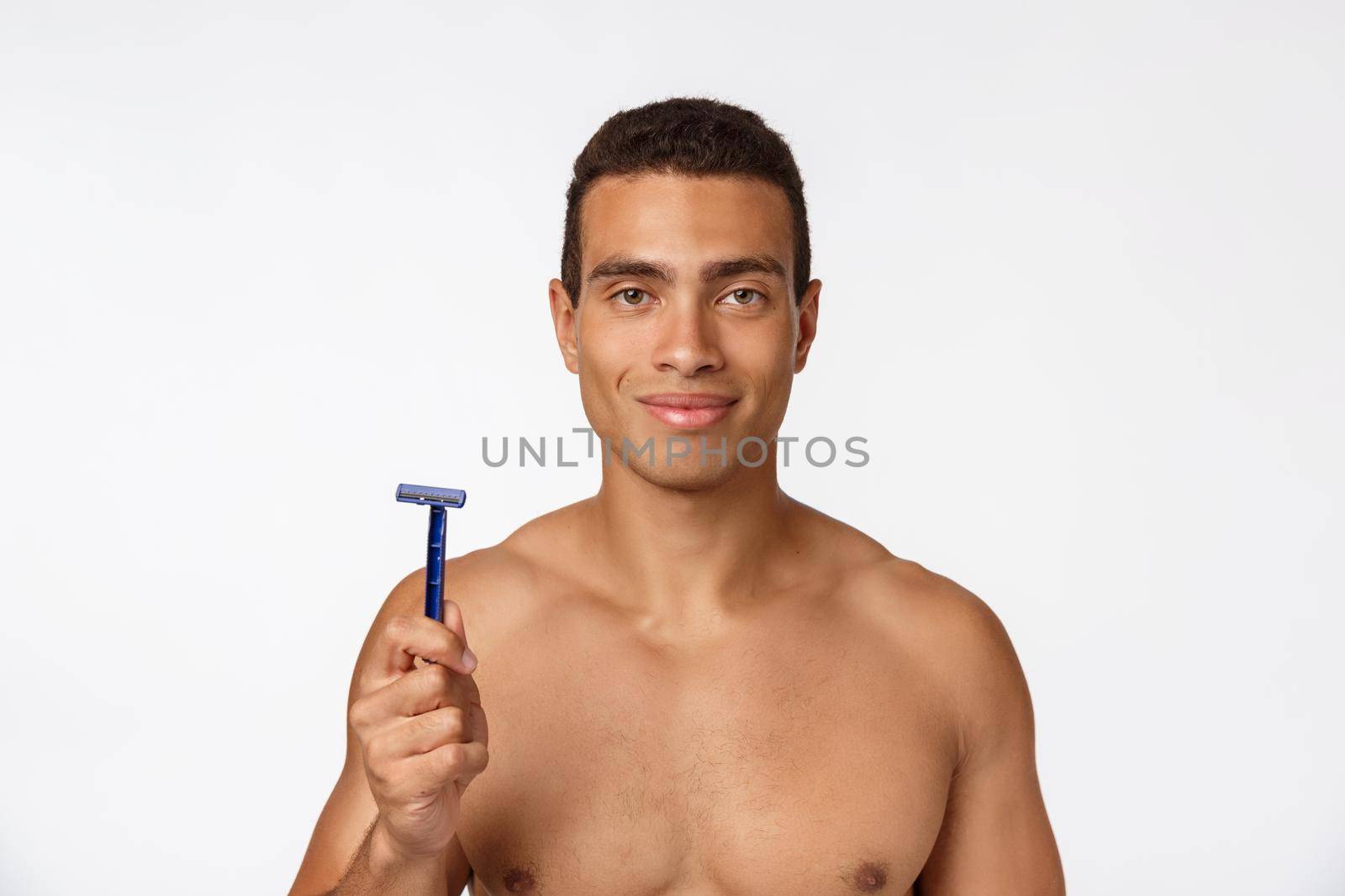 Close up of a happy naked african man holding razor isolated over gray background. by Benzoix