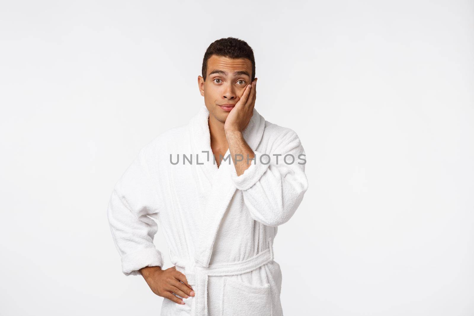 African American guy wearing a bathrobe with happy emotion. Isolated over whtie background