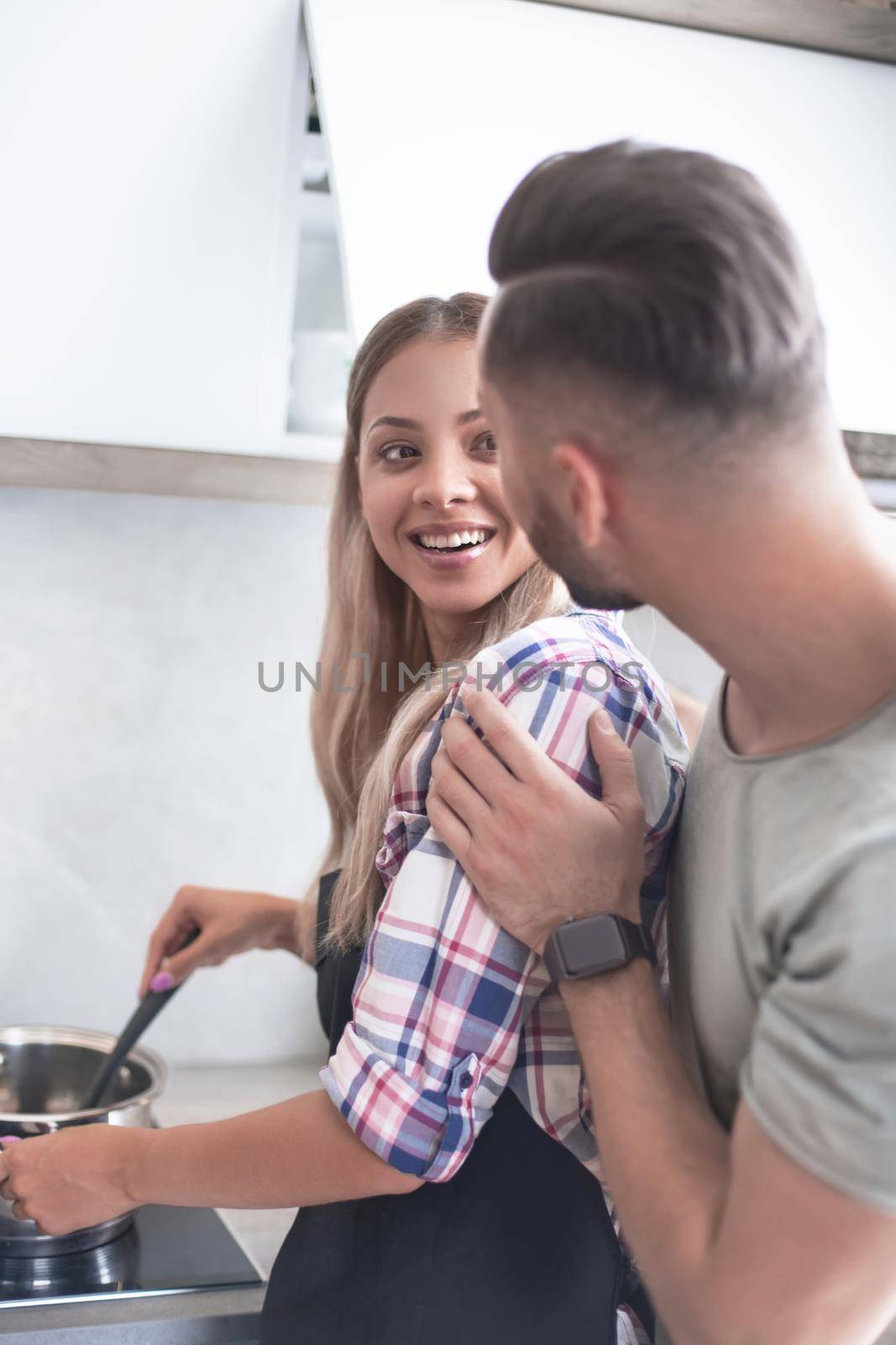 close up. young man joking with his wife in the kitchen