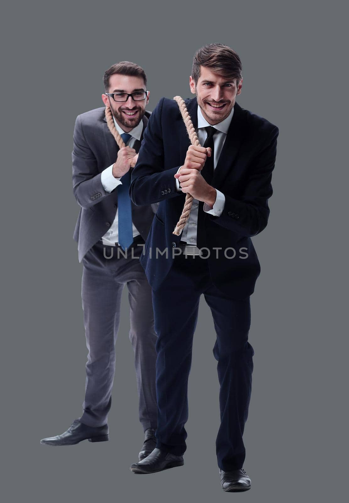 full length . two businessmen pulling a long rope. isolated on white background.