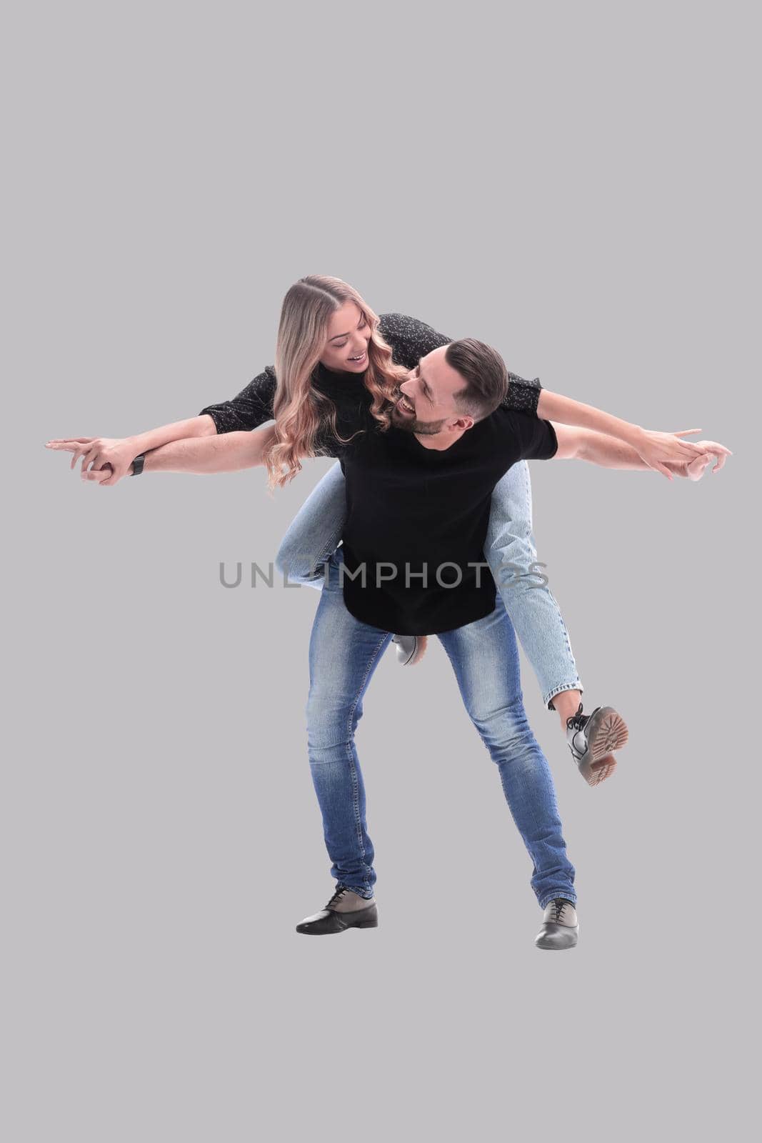 in full growth. a young couple in love is having fun . isolated on white background