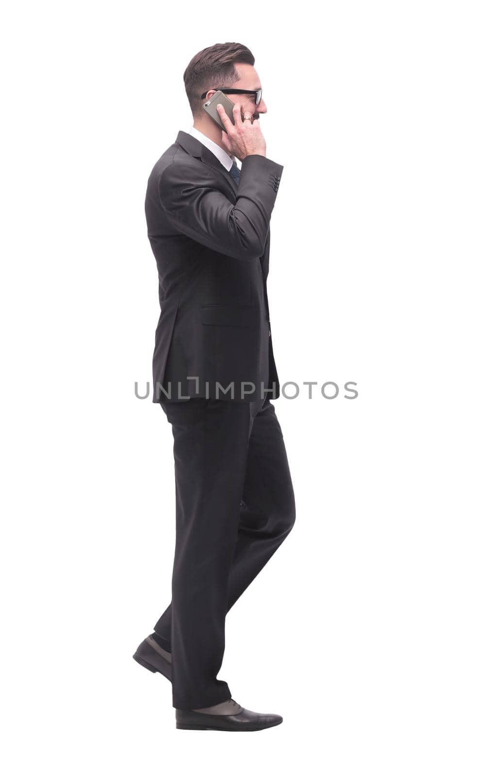 side view. businessman talking on his smartphone . isolated on white background