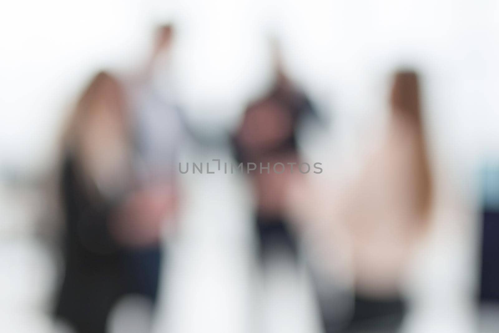 blurry image of employees standing in the office. by asdf