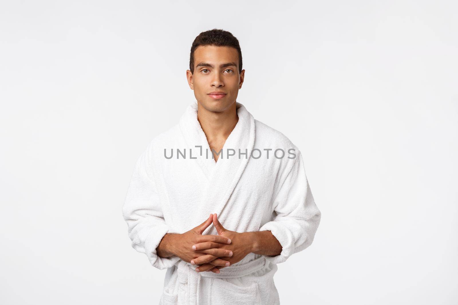 African American guy wearing a bathrobe with happy emotion. Isolated over whtie background