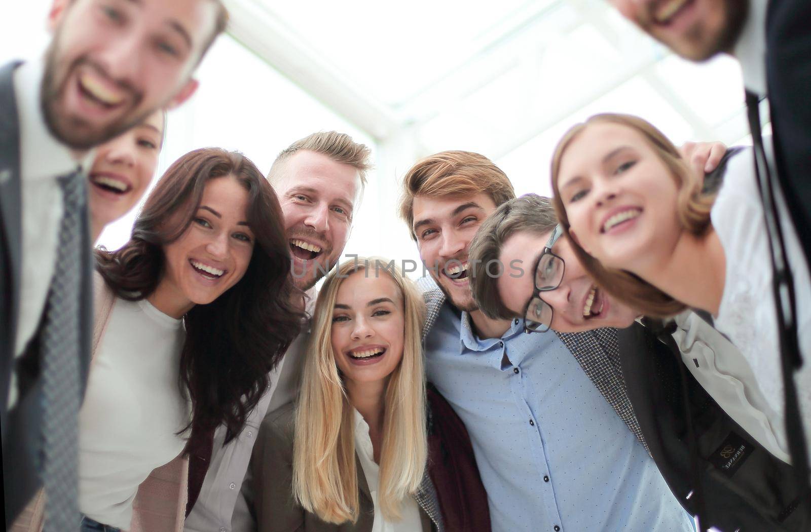 close up. group of smiling young people looking at the camera . by asdf