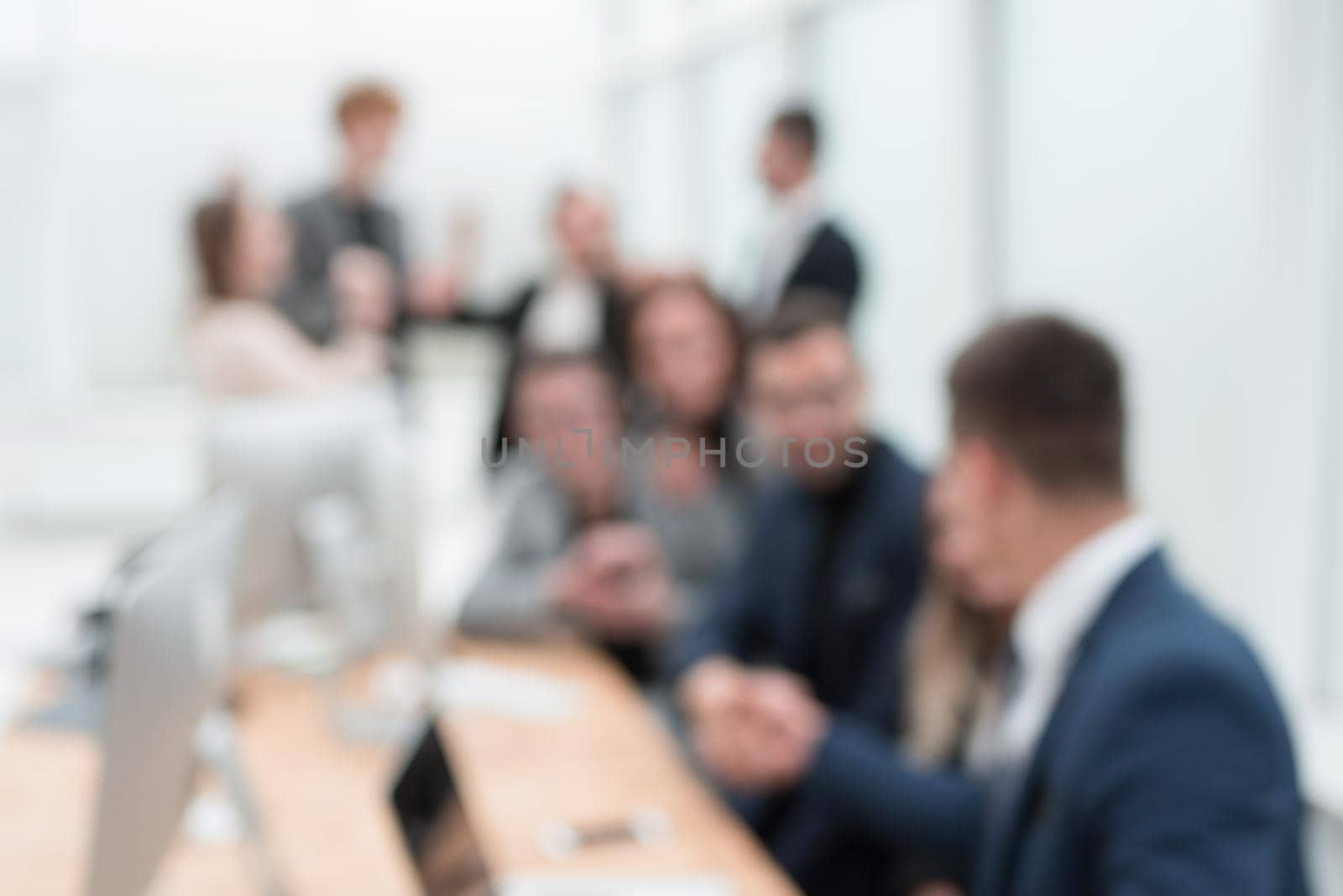 blurry image of a happy business team in the workplace. business background