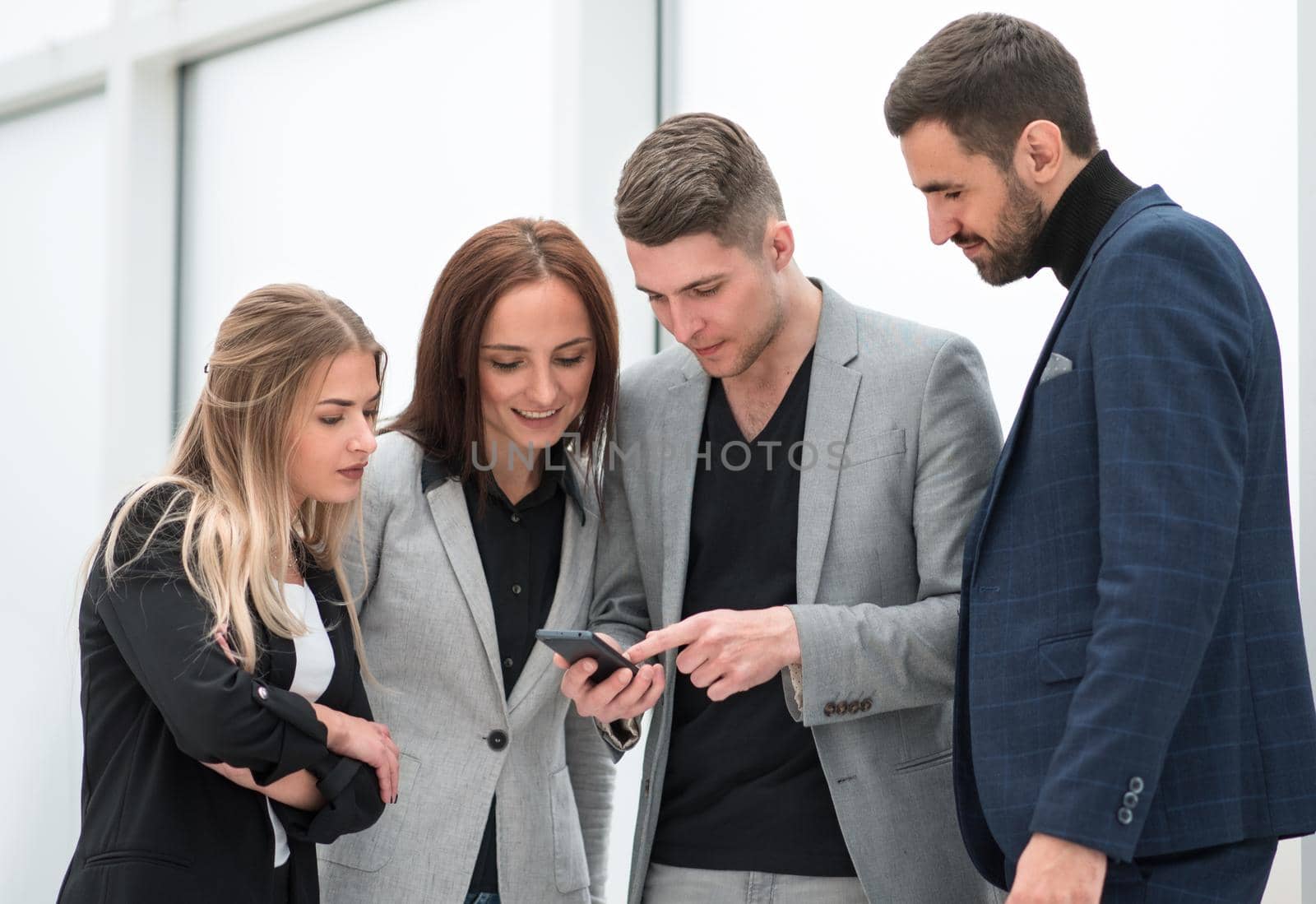 close up. employees reading SMS messages on the smartphone screen